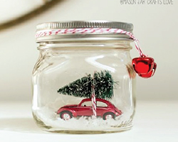 Snowglobe of car holding christmas tree