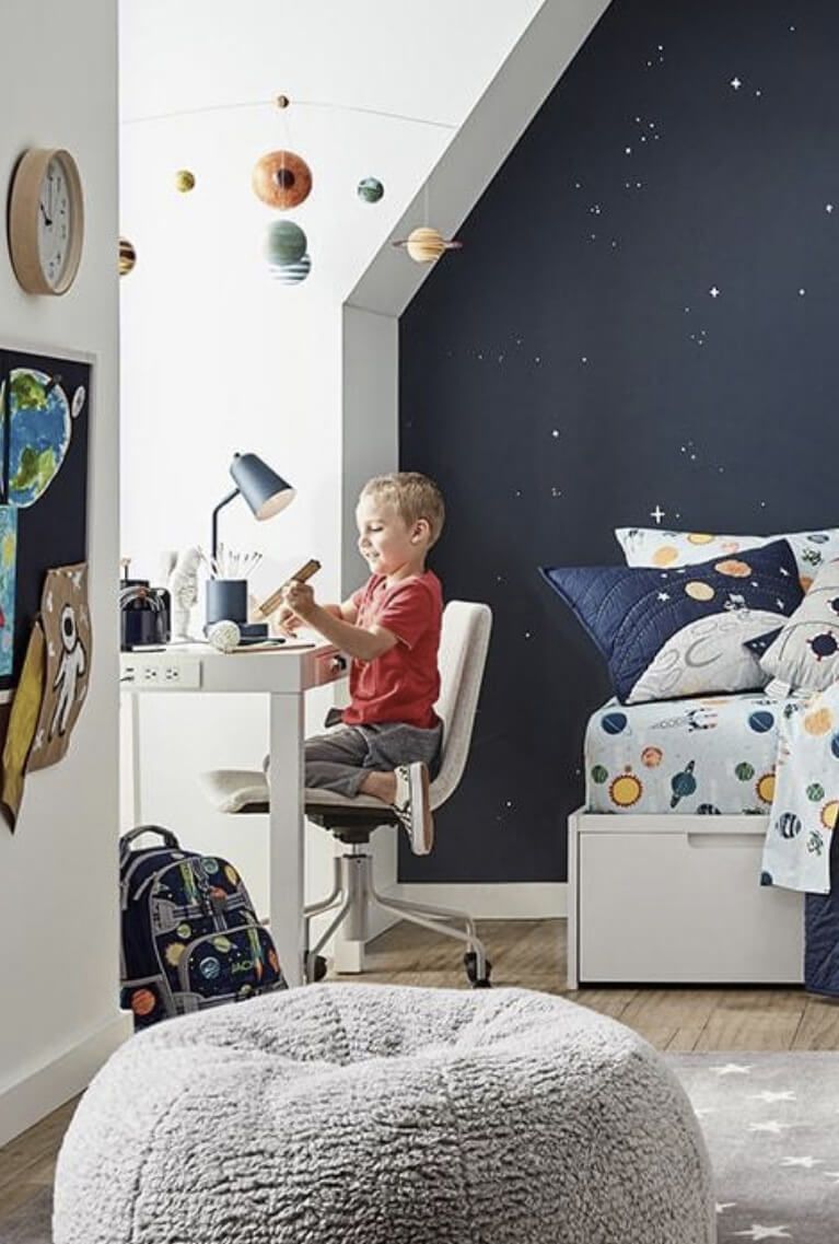 Child playing with a toy on his desk in bedroom